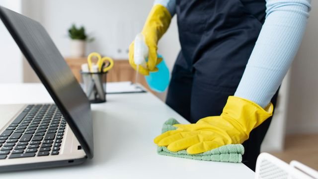 Professional cleaning an office workspace